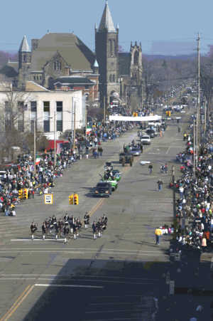 The 2004 St. Patrick's Day Parade drew enormous crowds as this photo of the event east on Center at Madison shows the Strathroy, Ontario, Pipe Band, followed by the Parade Association float. <small><br>Photo Andy Rogers</small>
